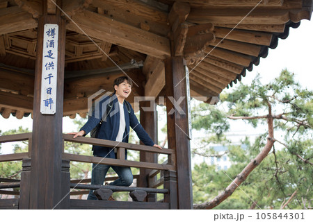 A young man doing a backpacking trip in a Korean traditional house.	 105844301