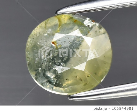 Natural gemstone green sapphire on gray background Natural gemstone green sapphire on gray background 105844981