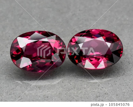 Natural gemstone red rhodolite garnet on gray background 105845076