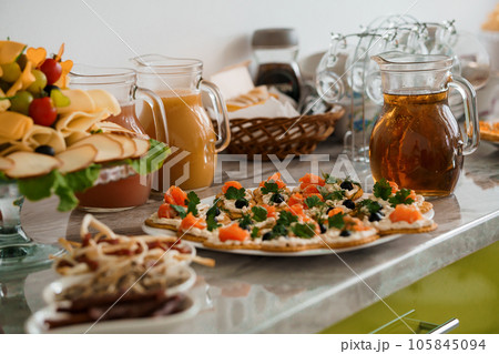 Canapes with salmon, cream cheese and greens. Festive buffet 105845094
