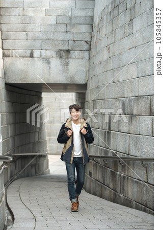 Young male college student traveling with a backpack in Korea Young male college student traveling with a backpack in Korea 105845357
