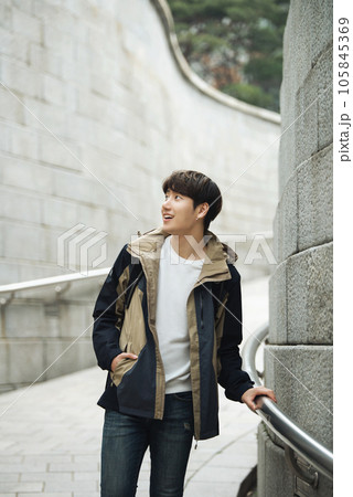 Young male college student traveling with a backpack in Korea 105845369