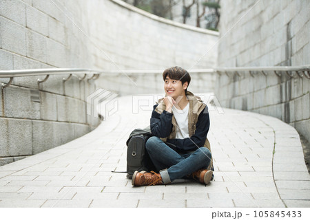 Young male college student traveling with a backpack in Korea 105845433