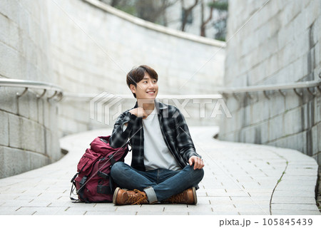 Young male college student traveling with a backpack in Korea 105845439