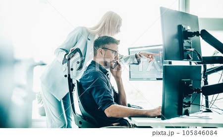 Stock broker business team trading online watching charts and data analyses on multiple computer screens in modern corporate work station office. Stock broker business team trading online watching charts and data analyses on multiple computer screens in modern corporate work station office. 105846084
