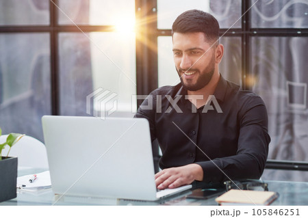 Middle-aged man working on laptop in office 105846251