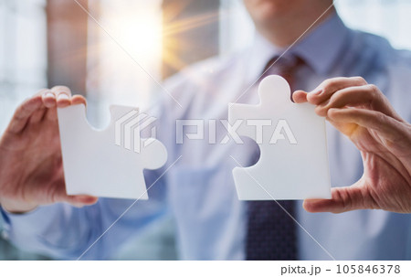optimistic businessman holding a puzzle piece, solving problems, optimistic businessman holding a puzzle piece, solving problems, 105846378
