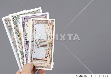 Old Lebanese money in the hand on a gray background Old Lebanese money in the hand on a gray background 105846454