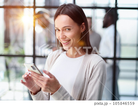 Businesswoman with phone in modern office 105846559