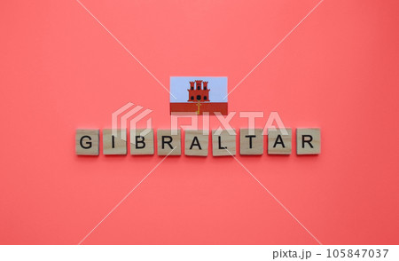 September 10, Gibraltar National Day, flag of Gibraltar, minimalistic banner with the inscription in wooden letters 105847037
