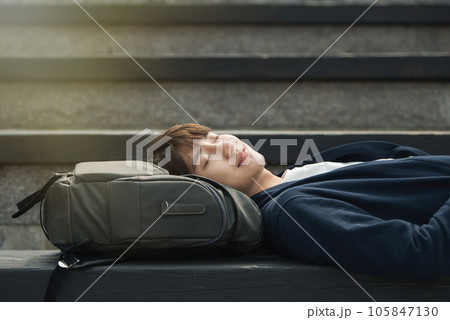 a young man resting on the stairs 105847130