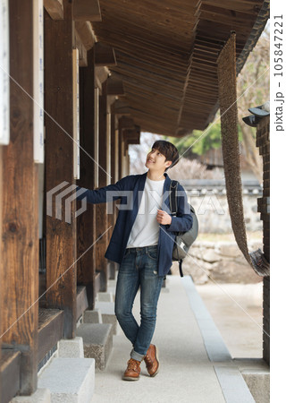 Young male college student traveling with a backpack in Korea Young male college student traveling with a backpack in Korea 105847221