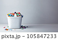 Plastic white basket full of crumpled colourful paper on the white background 105847233