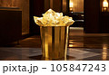 Golden metal basket full of crumpled golden paper in the luxury hotel 105847243