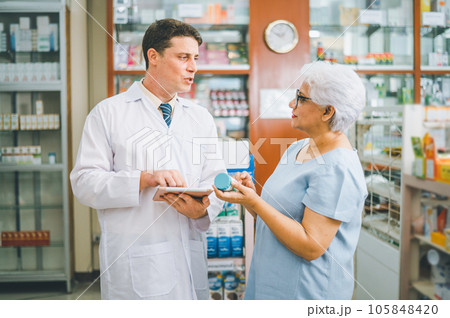 Pharmacist giving advice And advice for patients who come to buy Medicine, Drugs, Vitamins products, according to prescriptions in modern pharmacies. Pharmacist giving advice And advice for patients who come to buy Medicine, Drugs, Vitamins products, according to prescriptions in modern pharmacies. 105848420