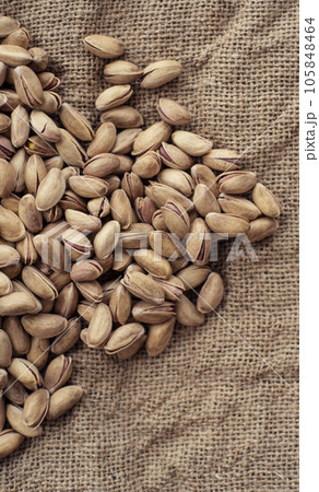Pistachios on burlap sack. Healthy food high protein. Dietary nutrition. close-up Pistachios on burlap sack. Healthy food high protein. Dietary nutrition. close-up 105848464