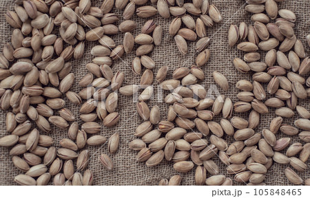 Pistachios on burlap sack. Healthy food high protein. Dietary nutrition. close-up Pistachios on burlap sack. Healthy food high protein. Dietary nutrition. close-up 105848465
