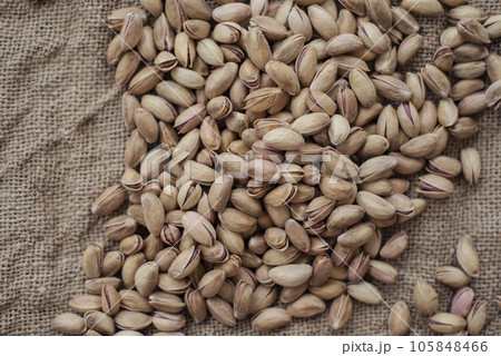 Pistachios on burlap sack. Healthy food high protein. Dietary nutrition. close-up Pistachios on burlap sack. Healthy food high protein. Dietary nutrition. close-up 105848466
