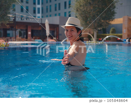 asian woman relaxing in swimming pool spa asian woman relaxing in swimming pool spa 105848604
