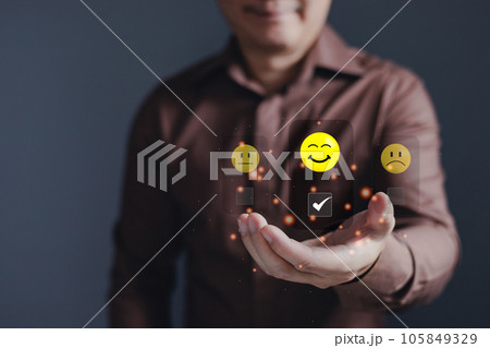 hand of customer or client holding smile face to complete five stars with copy space.Service rating,giving a five star rating.satisfaction concept. 105849329