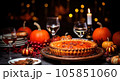 Thanksgiving pumpkin pie is elegantly served with candles on a wooden table  105851060