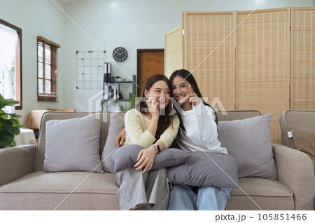 Asian lesbian woman couple enjoy watch TV together in house and feel happy watch movie on television. Homosexual-LGBTQ concept. 105851466