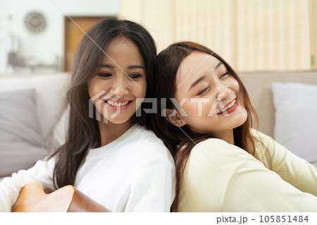 LGBTQIA lesbian gay couple playing guitar and singing with romantic feelings at home 105851484