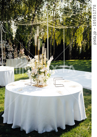 Wedding. Banquet. The chairs and round table for guests, served with cutlery. 105851778