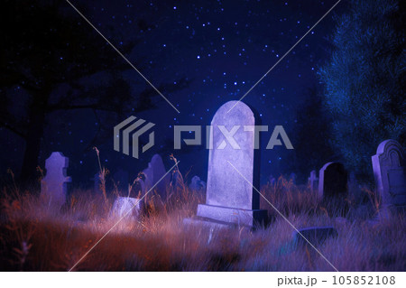 Weathered gravestone standing in an old abandoned cemetery, among dry autumn grass at night 105852108
