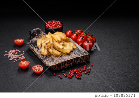 Delicious crispy potato deeps with salt and spices on a textured concrete background 105855371