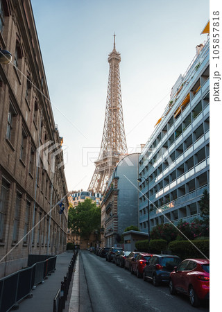 Sunset view of the Eiffel Tower from a Parisian street, with a warm brown and white color scheme. Sunset view of the Eiffel Tower from a Parisian street, with a warm brown and white color scheme. 105857818