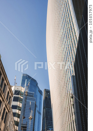 22 Bishopsgate and 20 Fenchurch Street in city. Iconic towers of London with blue sky in background. Financial district on sunny day. 105857975