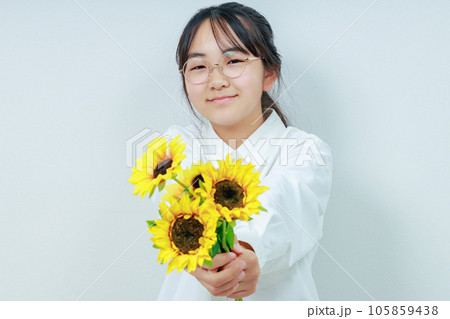 向日葵を差し出す笑顔の眼鏡女子 105859438