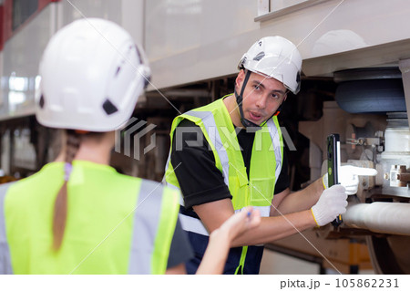 Young caucasian engineer man and woman meeting and checking electric train for planning maintenance. Young caucasian engineer man and woman meeting and checking electric train for planning maintenance. 105862231
