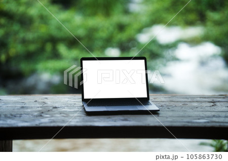 Laptop computer on the balcony by the water, relaxing work 105863730