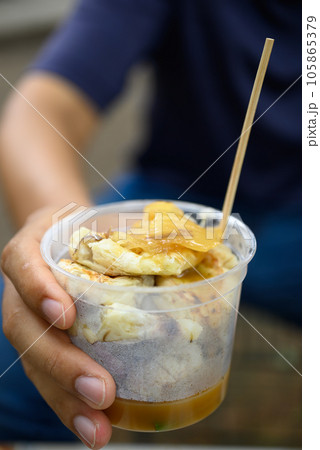 Grilled banana eating with coconut caramel sauce, Traditional Thai dessert Grilled banana eating with coconut caramel sauce, Traditional Thai dessert 105865379
