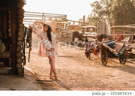 pregnant woman in a dress and hat in the countryside pregnant woman in a dress and hat in the countryside 105865634