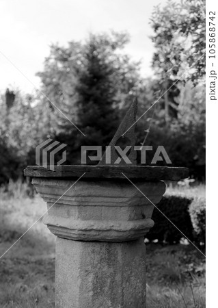 Very old sundial shows time in dense vegetation forest Very old sundial shows time in dense vegetation forest 105868742