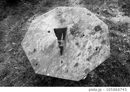 Very old sundial shows time in dense vegetation forest Very old sundial shows time in dense vegetation forest 105868743