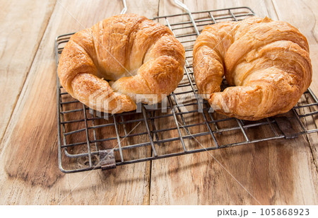 Fresh croissants on old wooden table 105868923