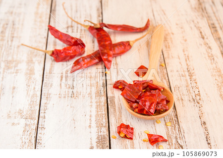 Dried Chili Peppers on wooden background Dried Chili Peppers on wooden background 105869073