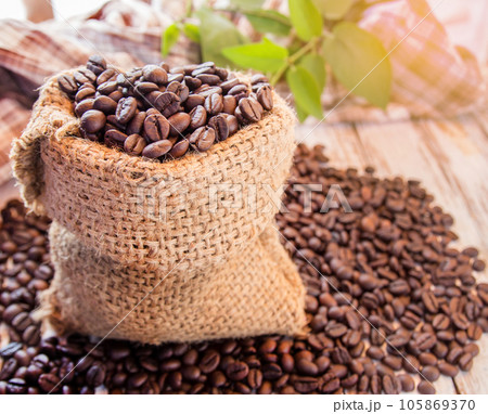 Roasted coffee beans in burlap sack Roasted coffee beans in burlap sack 105869370