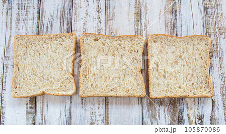 Whole wheat bread on white wooden background 105870086