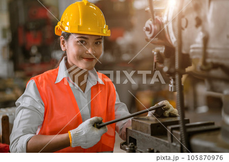 happy young asian woman worker with heavy metal machine lathe milling factory industry happy young asian woman worker with heavy metal machine lathe milling factory industry 105870976