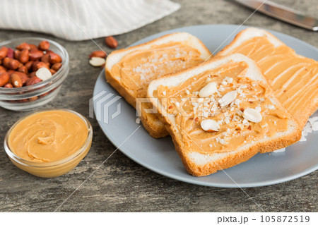 Peanut butter sandwiches or toasts on light table background.Breakfast. Vegetarian food. American cuisine top view vith copy space Peanut butter sandwiches or toasts on light table background.Breakfast. Vegetarian food. American cuisine top view vith copy space 105872519