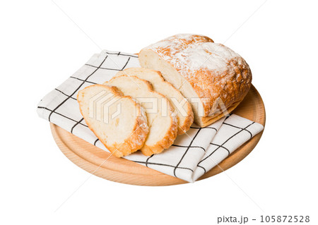 Assortment of freshly sliced baked bread with napkin isolated on white background. Healthy unleavened bread. French bread slice 105872528