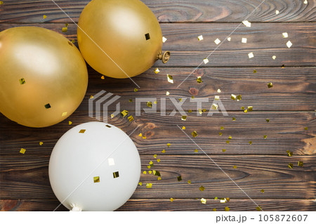 Background with fastive air balloons of round shape and confetti, multicoloured top view. Birthday party background Background with fastive air balloons of round shape and confetti, multicoloured top view. Birthday party background 105872607