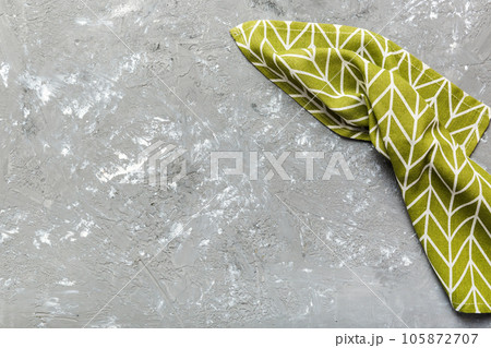 top view with green kitchen napkin isolated on table background. Folded cloth for mockup with copy space, Flat lay. Minimal style 105872707
