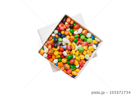 Set of different sweet candy in a paper box with a satin ribbon on a colored background. Holiday concept 105872734