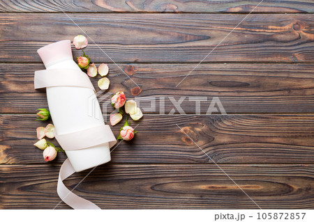 Fancy healthcare bottles for cream with rose flower. Natural oranic spa cosmetics concept. Mockup, template, Top view 105872857